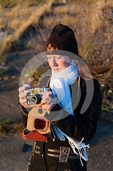 A girl photographer with an old camera