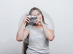 Girl photographer takes a photo with an old film camera