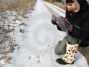 Girl Photographing Animal Traces