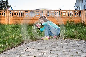 Girl photographing in the garden