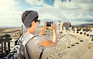 The girl is photographing the phone ruins. Journey. Tunisia, Dougga.