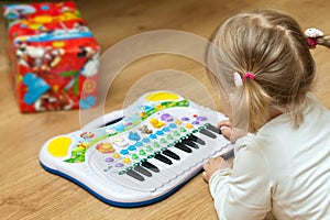 Girl with piano toy