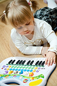 Girl with piano toy