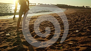 Girl pick up plastic from polluted coast on beach ocean