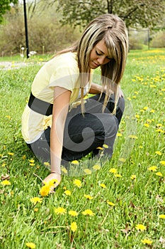 Girl picking dandelion