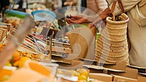 Girl picking out fresh produce at a market.