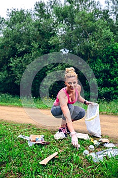 Girl picking up trash doing plogging