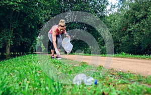 Girl picking up trash doing plogging