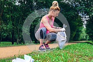 Girl picking up trash doing plogging