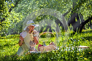 Girl on picnic in Park opens jar of cookies