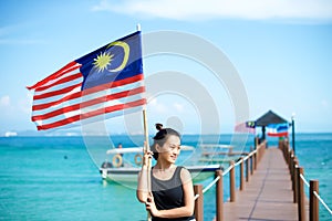 Girl on pier with Malaysian flag