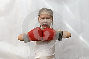 Girl with pigtails in boxing gloves