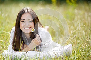 The girl with a pillow on the fresh spring grass.