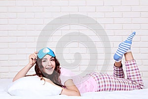 Girl with pillow and sleeping mask lying