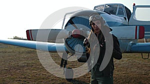 Girl pilot near the plane