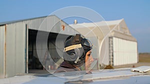 Girl pilot near the plane