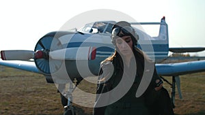 Girl pilot near the plane