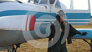 Girl pilot near the plane