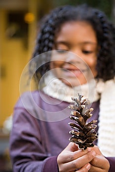 Girl with a pine cone