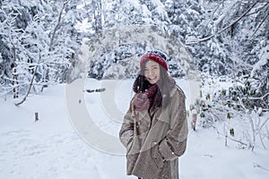 Girl in the pine forest with snow everywhere