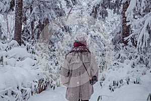 Girl in the pine forest with snow everywhere