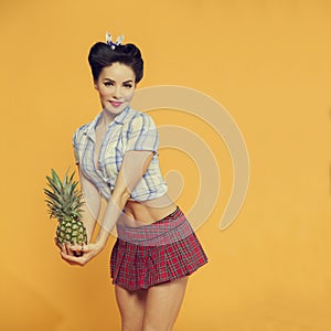 Girl with a pineapple in his hands