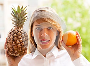 Girl with pineapple and orange