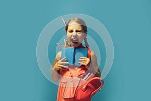 Girl with pink bag holds open blue notebook