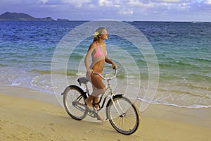 Girl in pink bikini riding her bike