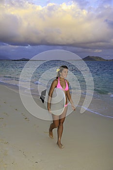 Girl in pink bikini with surfboard