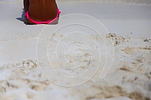 Girl in pink bikini on tropical beach