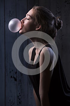 Girl with pink bubble of chewing gum