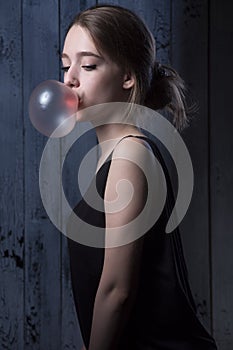 Girl with pink bubble of chewing gum