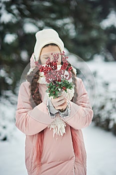 Girl in pink coat in snow Park. Girl plays in winter Park. Adorable child walking in snow winter forest