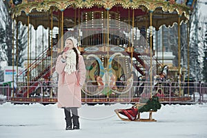 Girl in pink coat in snow Park. Girl plays in winter Park. Adorable child walking in snow winter forest