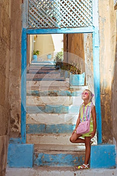Girl in pink glasses standing on stairs, Alicante
