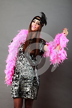 Girl pink plume and black feather on head. Carnival.