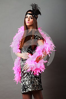 Girl pink plume and black feather on head. Carnival.