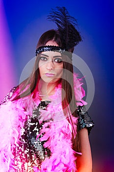 Girl pink plume and black feather on head. Carnival.