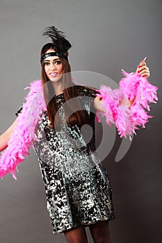 Girl pink plume and black feather on head. Carnival.