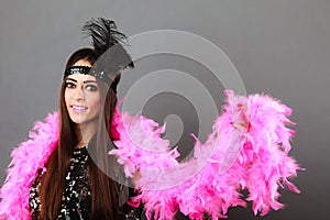 Girl pink plume and black feather on head. Carnival.