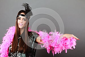 Girl pink plume and black feather on head. Carnival.