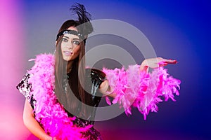 Girl pink plume and black feather on head. Carnival.