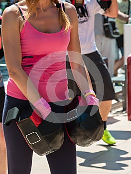 Girl in Pink Sportswear doing Fitness with Punching Mitts in Out