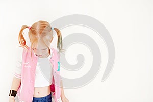 Girl in a pink sweatshirt on the white background