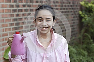 Girl in pink watering flowers