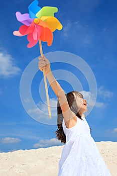 Girl with pinwheel on beach