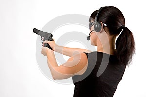 Girl with pistol and headphones.