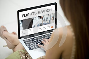 Girl planning round trip flight using laptop online