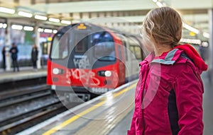 Girl on the platform waiting for a train